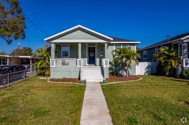 Bungalow-style homes in Fossil Park feature palm trees in the front yard.