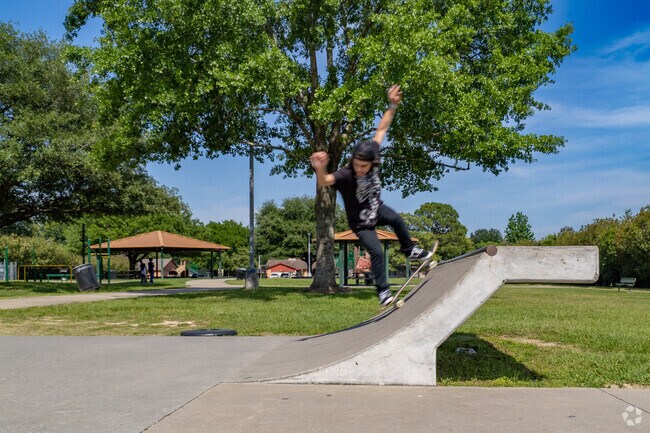 A young man attempts a move at Vogel Creek Skatepark located within North Houston.