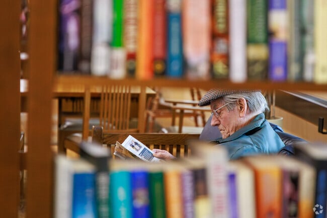 A man sits and reads a book at Fayetteville Free Library in Fayetteville.
