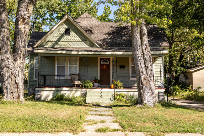 A well maintained bungalow sits between two large trees in Byers and Murphy.