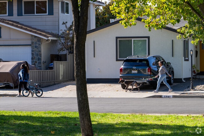 Neighbors enjoy vibrant Castlemont streets on sunny afternoons.