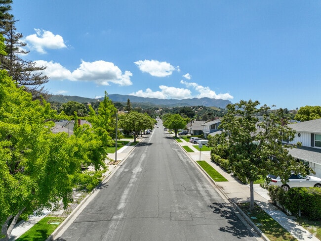 The streets of Casa Conejo are lined with lush trees and framed by beautiful mountains.