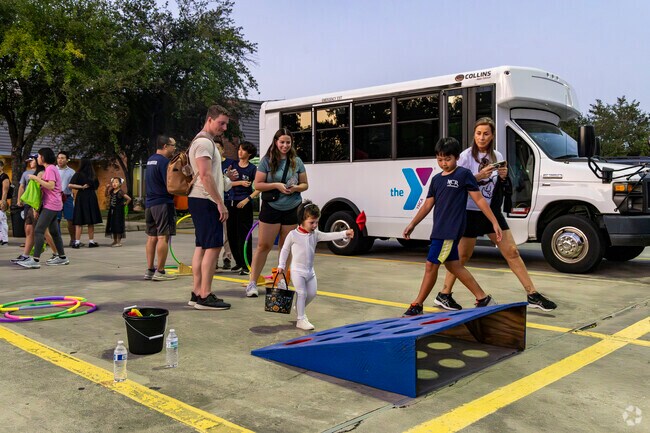 A young boy plays the bean bag tog game at the Halloween at the Y event.