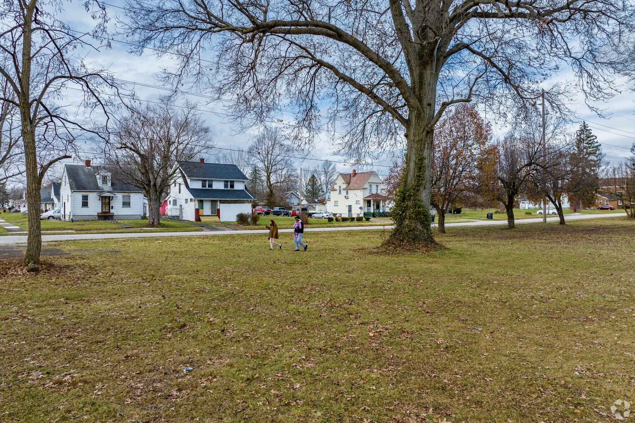 A young family enjoys a walk through Quinby Park in the Southeast neighborhood of Warren.