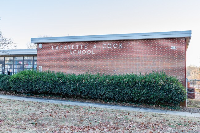 Cook Literacy Model School has a campus adorned with trees.