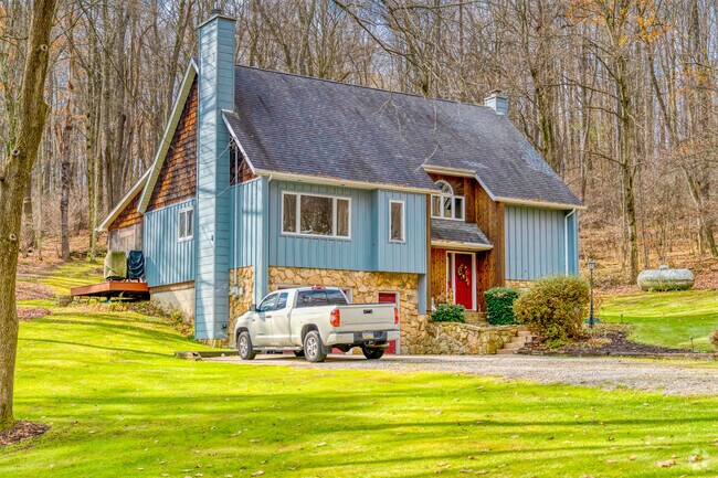 Enjoy timeless charm and privacy on a spacious wooded lot in Independence Township.