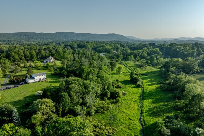 The outskirts of Warwick hold forest, farmland, and rural properties on winding backroads.