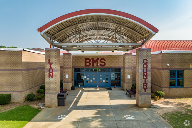 The welcoming entrance to Mary McLeod Bethune Middle School is located in the vibrant Stone Mountain district, surrounded by lush greenery and a sense of community.
