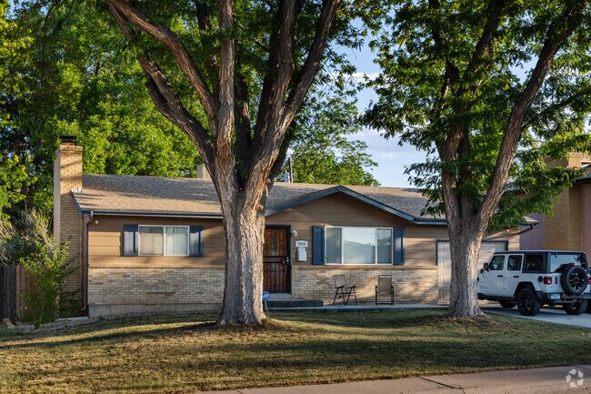 Tall trees shade a Ranch-style home in Highland Park.