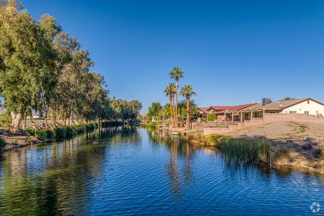 Nestled along the river in Needles, CA homes mirror tranquil waters, embodying a serene haven.