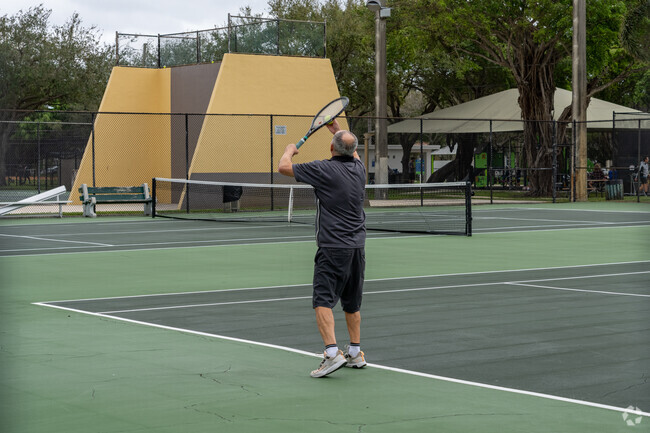 Parkside residents playing tennis at the park.