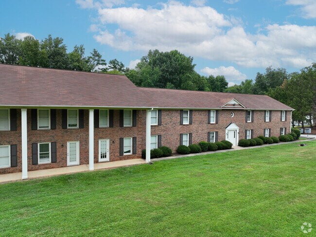 The traditional brick townhouses are located in the northern area of University City North, NC.