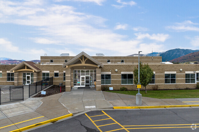 Valley Elementary School sits under a cloudy sky in the the colorful, fall mountains.