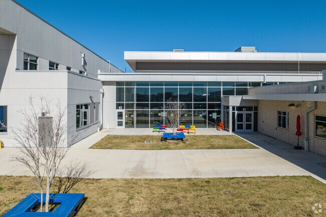 Colorful benches at Heritage Elementary School invite stories under the Texas sun.