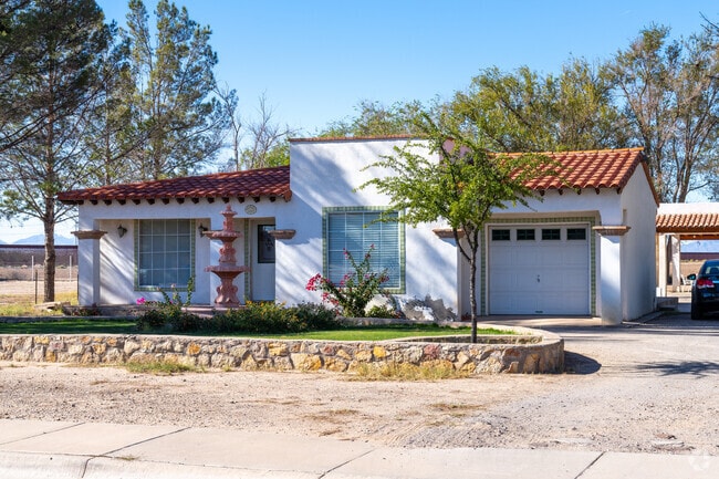 Spanish Revival home with striking white stucco walls and red tile roof in San Elizario.