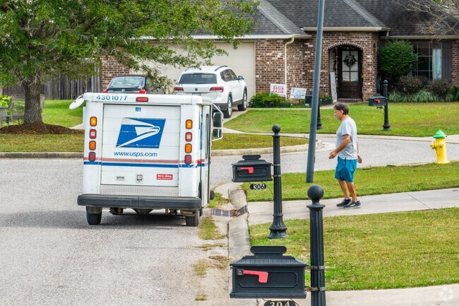 A mailman delivers mail to residents of Youngsville, Louisiana.