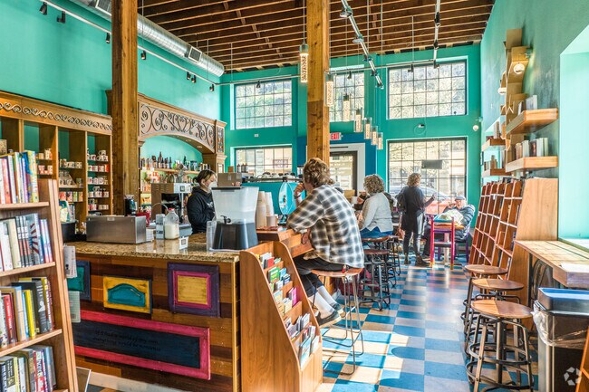 Friends chat and sip coffee at Black Ink Coffee, a cozy café near McLoughlin.