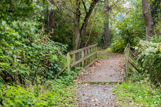 Cross over bridges and enjoy the stream at Creek Side Park and Nature Trail.