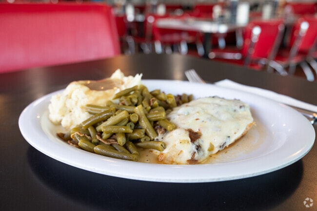 Smothered Chicken with green beans, mash potato and gravy dish that you can enjoy in Nelson`s Diner in Garden Isles neighborhood