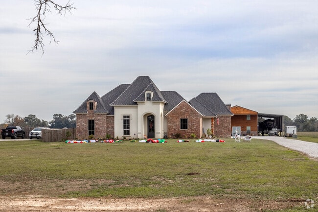 A two-story, French-style Mansion with a detached boat garage in Carencro.