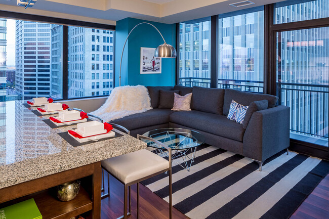 Nic on 5th Apartments in Minneapolis, Minnesota- Furnished large living room with floor to ceiling views of Downtown West Minneapolis