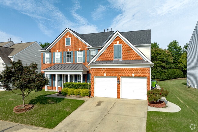 Brick colonial homes have large yards in Crabtree.