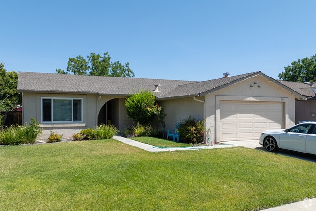 Ranch-style simplicity meets elegance in this Shawnee home with its arched porch and tidy yard.