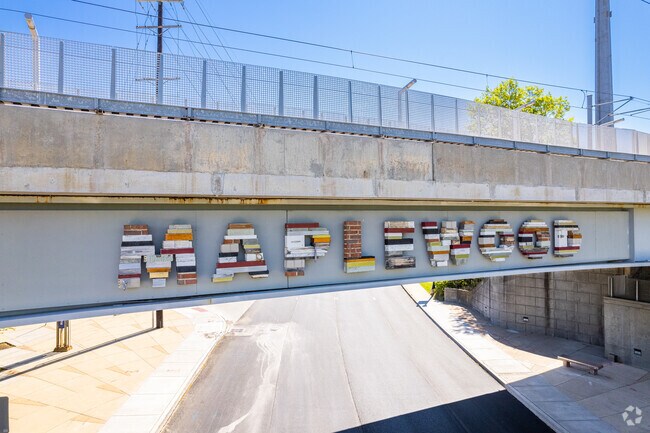 Visitors to Maplewood are greeted by a sign on the MetroLink bridge crossing Manchester Ave.