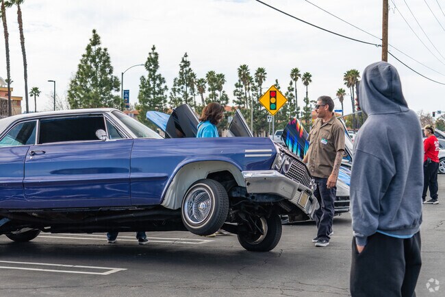 A lowrider is showing off on three wheels at the Love & Lowriders event near Lasselle.