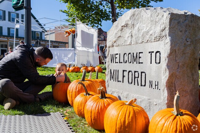 Pumpkins surround a welcome sign at the Milford Pumpkin Festival.
