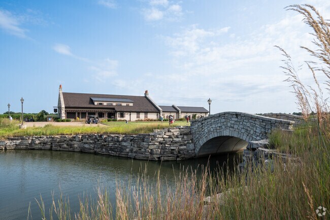 The cobblestone bridge across the pond at Mistwood Golf Club leads to the clubhouse.