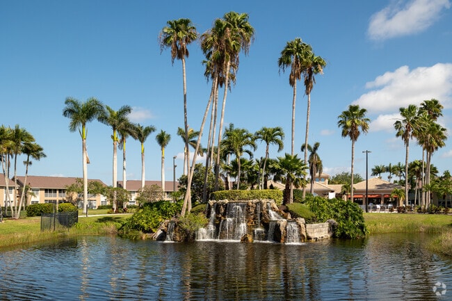 A park at the center of Parker Lake has a pool, tennis, a playground, trees, and a waterfall.
