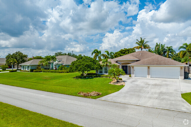 Row of single family homes in Tulip Park with manicured front lawns.
