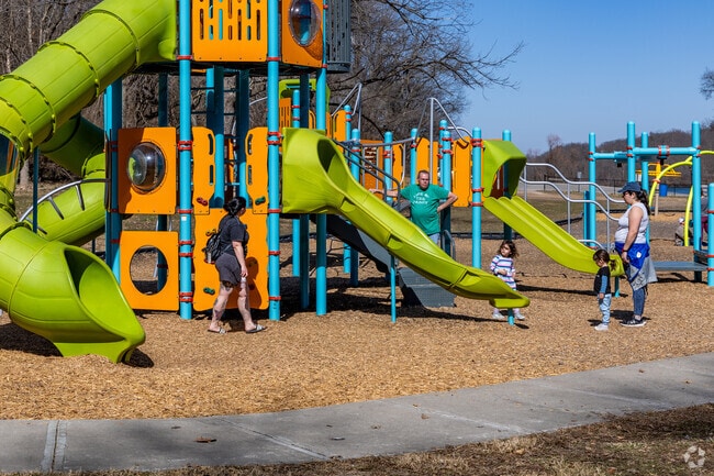 Kids climb and slide at the playground in Wyandotte County Lake Park in Kansas City, Kansas.
