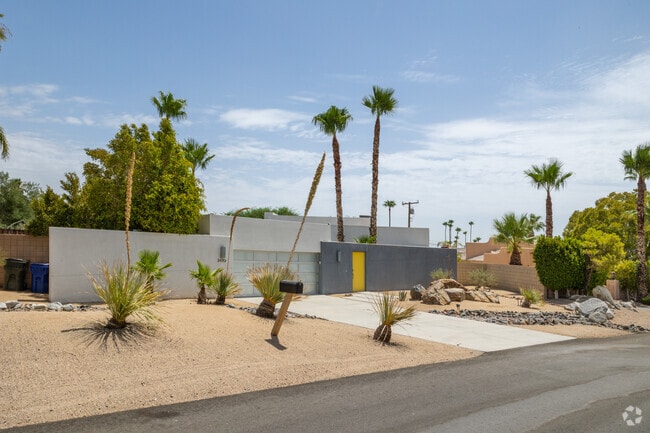 Modern home with a yellow front door seen in the Chino Canyon neighborhood.