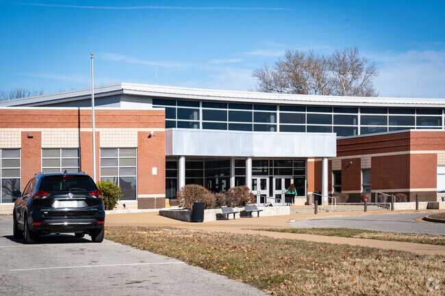 Carnahan High School stands out with the metal and brick architecture.