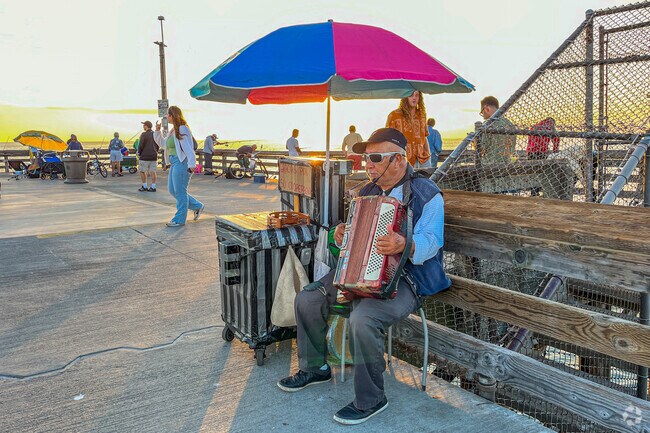 A musician plays in Newport Beach just a short bike ride away from Eastside Costa Mesa.