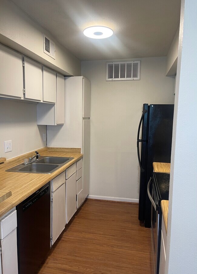 Kitchen with Bosch dishwasher. Upgraded kitchen faucet being installed.