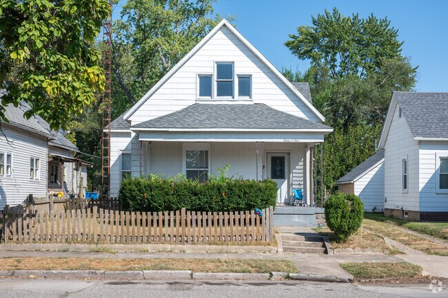 A picket fence lines the sidewalk in front of this Indiana State University home.