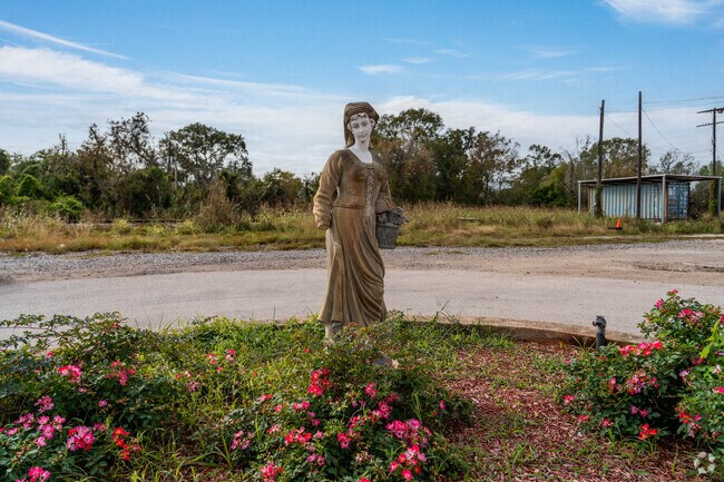 A comemorative statue sits along a road in Sweeny, Texas.