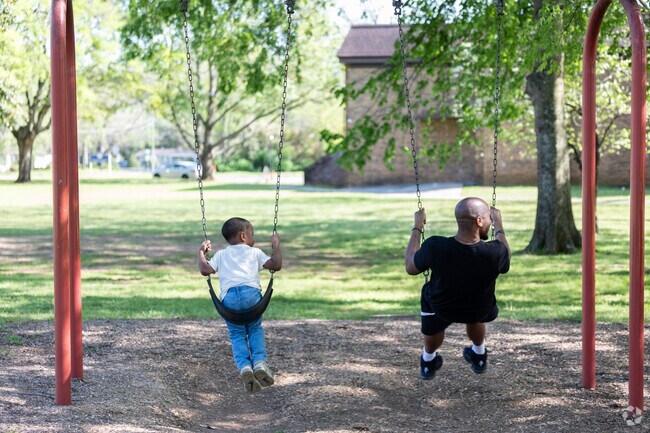 Families enjoy the swing sets at California Street park near the Twickenham Historic District.