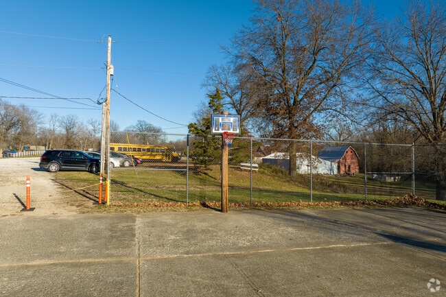 Troy Holiness School has a basketball court next to the school house.
