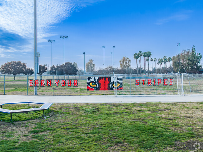 A fence sign encourages students of Los Tules Middle School in Tulare.