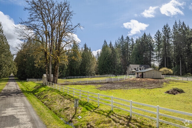 Properties in Fall City Orchard are sprawled out near country roads separated by tall trees.