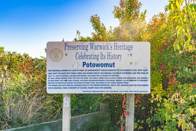 A sign on Sandy Point Beach detailing Potowomut's unique history.