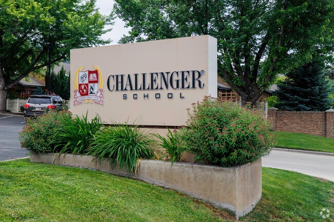 Challenger School’s concrete sign with curated plants at its base.