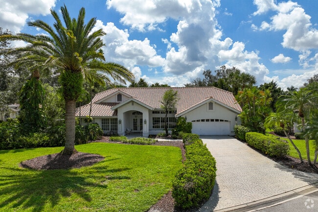 Large single-family home with a huge palm tree at the front yard in Gateway.