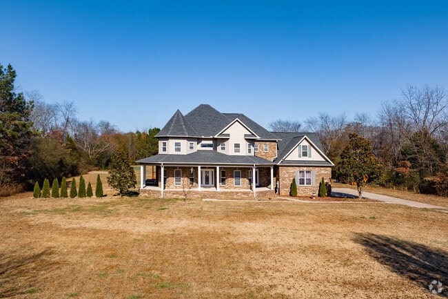 An amazing large home with a wrap around porch on a large lot in Ready Crossing.