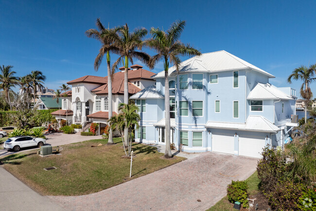 Looking down the rows of homes in beautiful Vanderbilt Beach finds a variety of architectural styles.