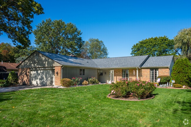 A grouping of rose bushes is sure to attract bees to this Tamarack home.